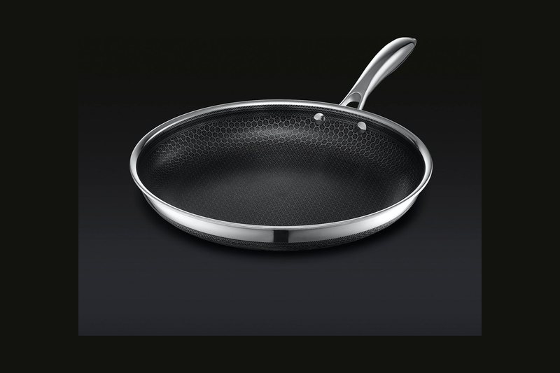 HexClad 12 inch hybrid frying pan with a black hexagon-patterned non-stick surface and stainless rim and handle