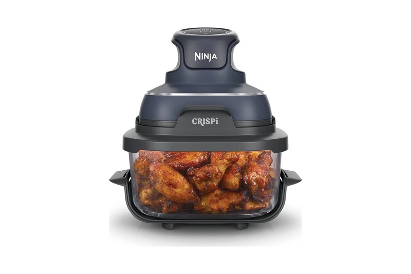 Ninja Crispi 4-in-1 portable glass air fryer with chicken wings in the glass container and the grey heating lid on top